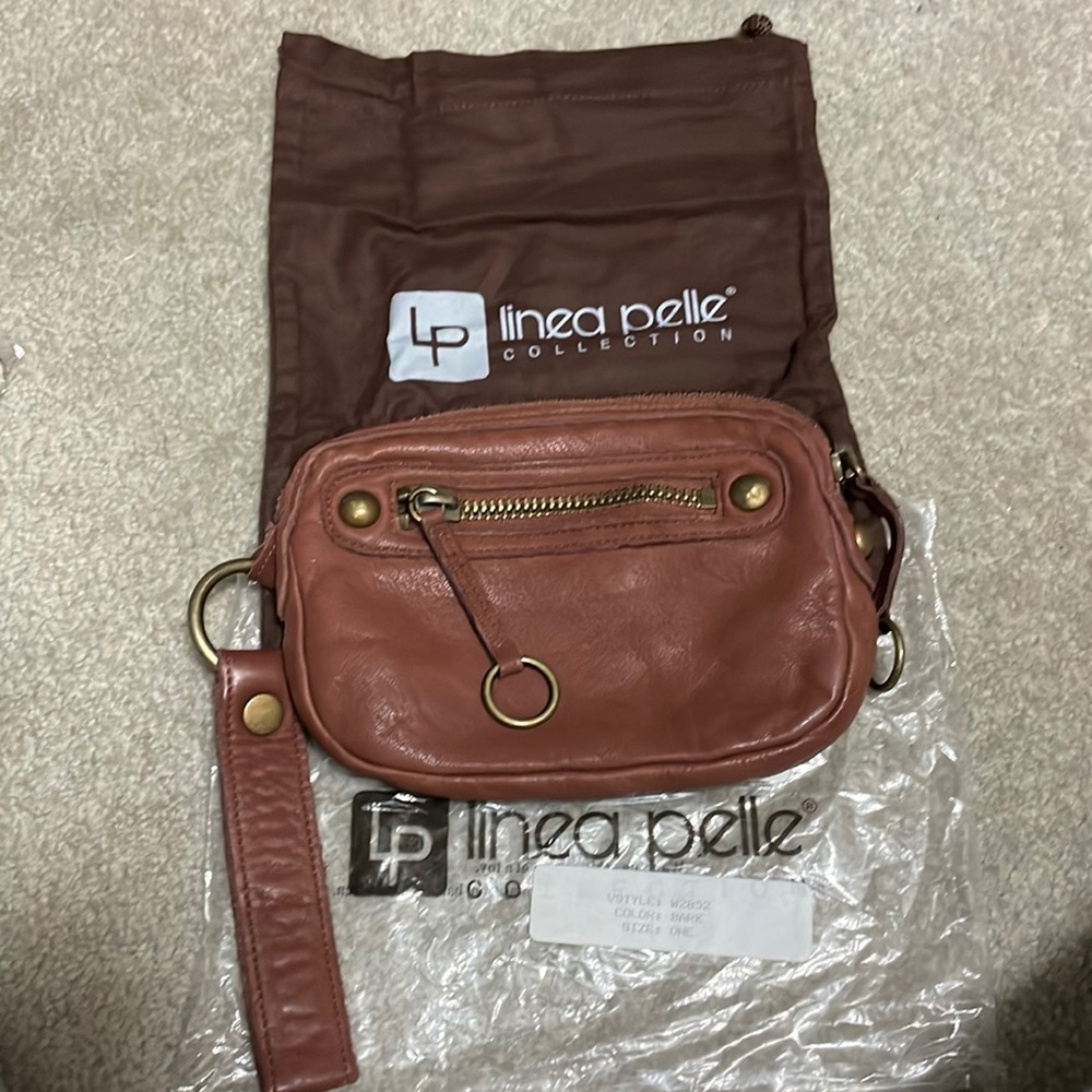New, LINEA PELLE leather wristlet. Inside zip pocket, front zip, and top zip.